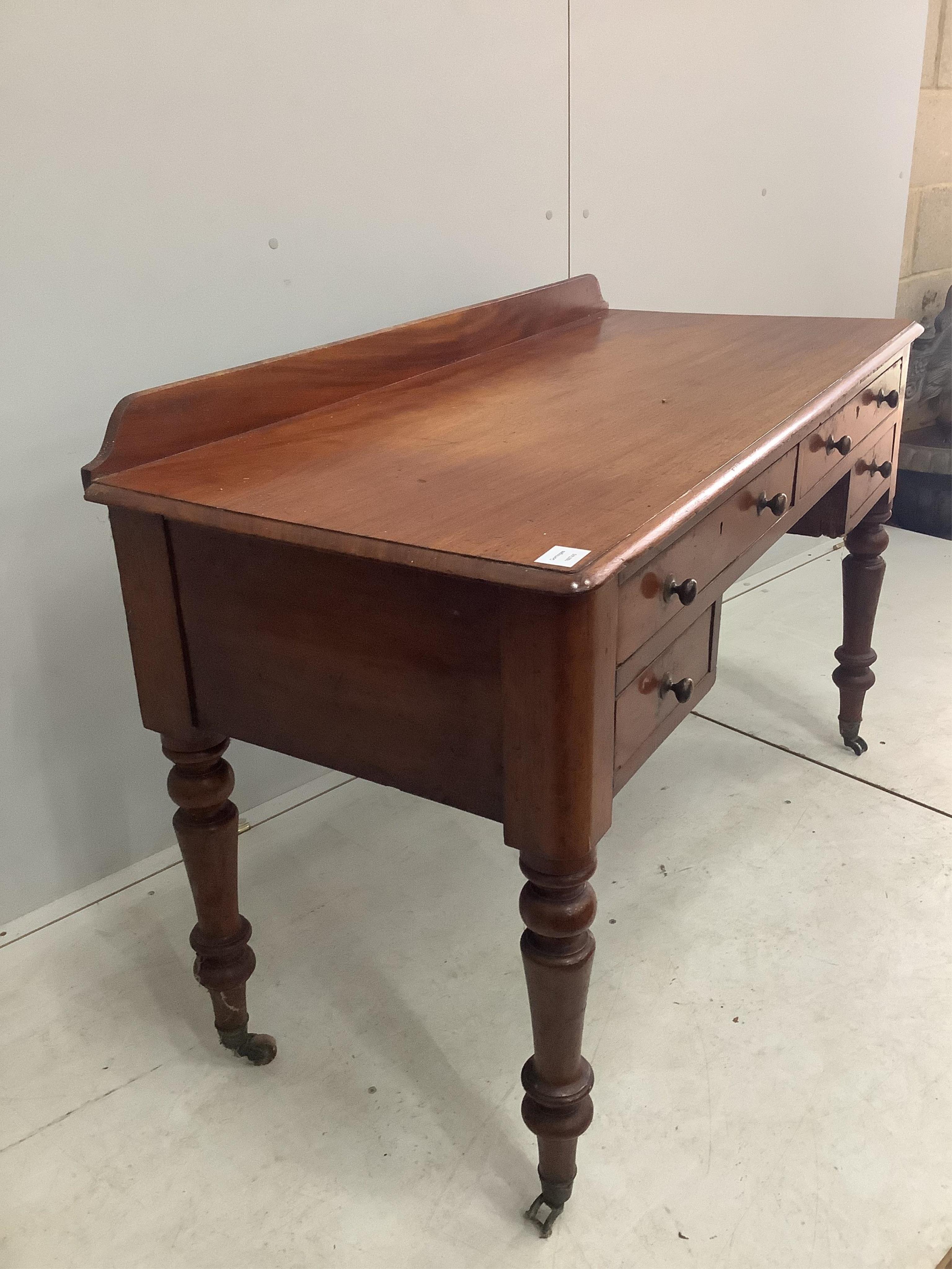 A Victorian mahogany four drawer side table, width 121cm, height 82cm. Condition - fair